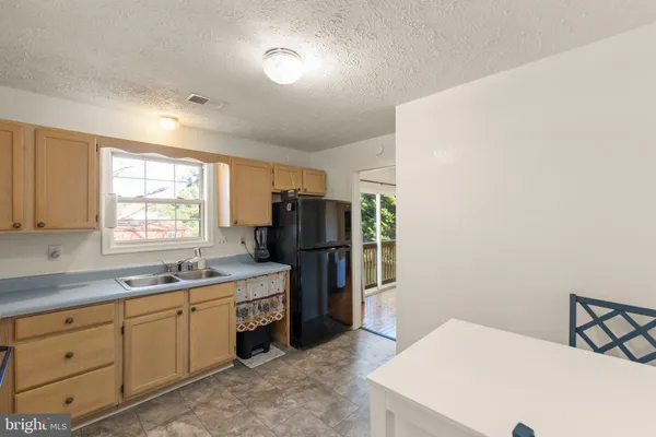 a kitchen with sink a window and appliances