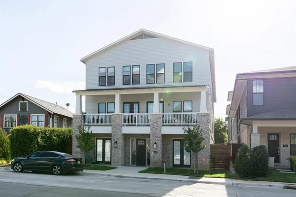 a front view of a residential apartment building with a yard