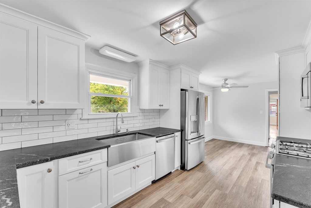 1127 East Street North Suffield, CT 06078 - Photo 11 of 40 a kitchen with granite countertop a sink stainless steel appliances and cabinets