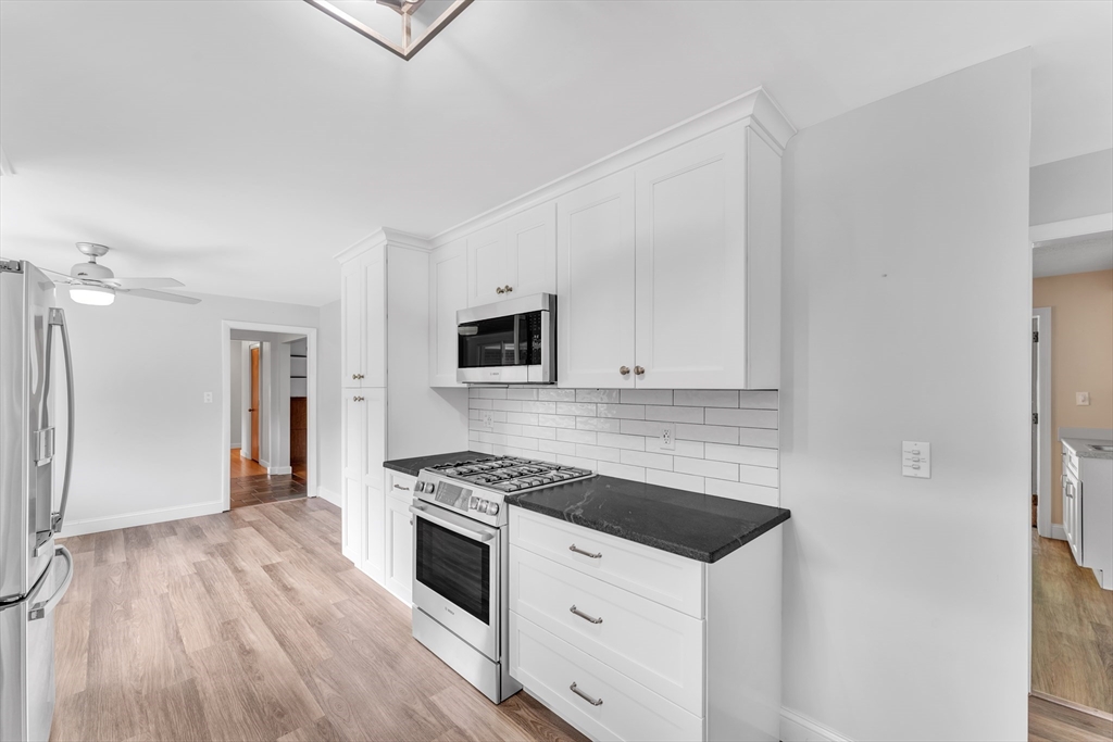 1127 East Street North Suffield, CT 06078 - Photo 12 of 40 a kitchen with granite countertop a sink cabinets and stainless steel appliances
