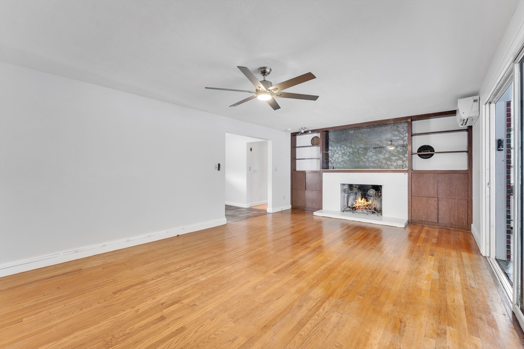 1127 East Street North Suffield, CT 06078 - Photo 15 of 40 wooden floor in an empty room with a fireplace