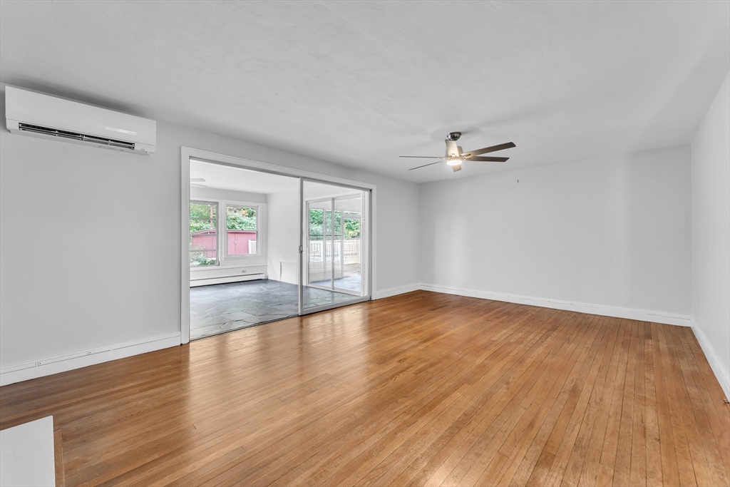 1127 East Street North Suffield, CT 06078 - Photo 16 of 40 a view of an empty room with wooden floor and a window