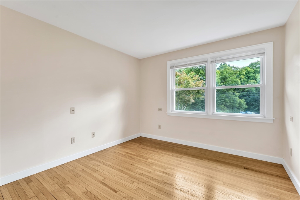 1127 East Street North Suffield, CT 06078 - Photo 19 of 40 a view of an empty room with wooden floor and a window