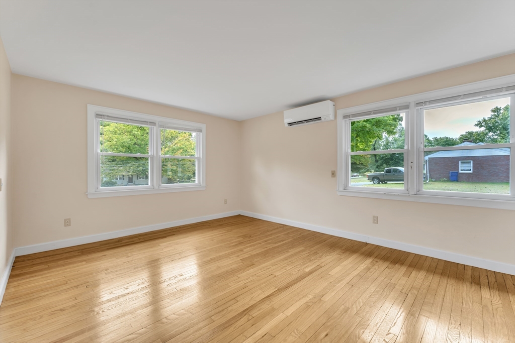 1127 East Street North Suffield, CT 06078 - Photo 21 of 40 a view of an empty room with wooden floor and a window