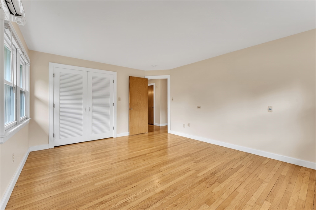 1127 East Street North Suffield, CT 06078 - Photo 22 of 40 a view of an empty room with wooden floor and a window