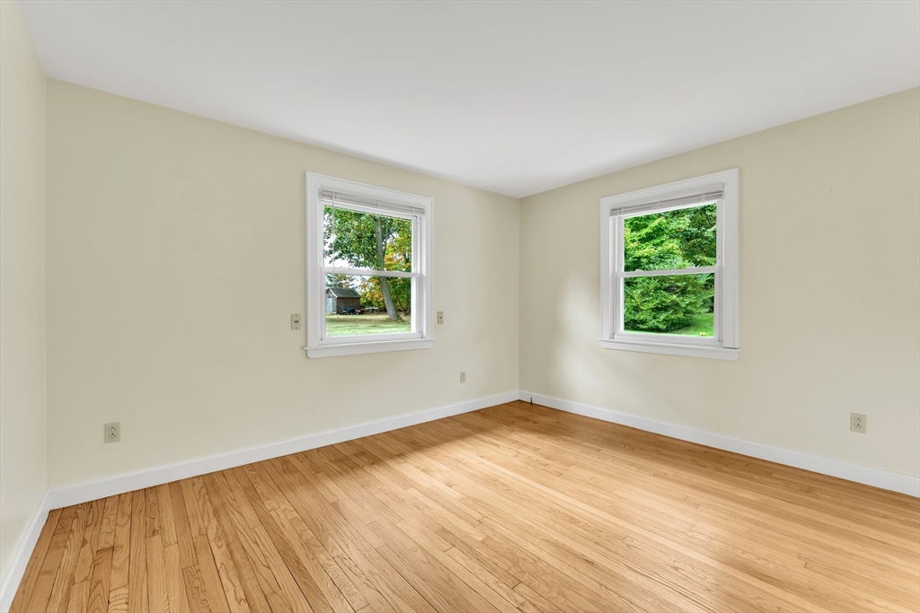 1127 East Street North Suffield, CT 06078 - Photo 23 of 40 a view of an empty room with wooden floor and a window