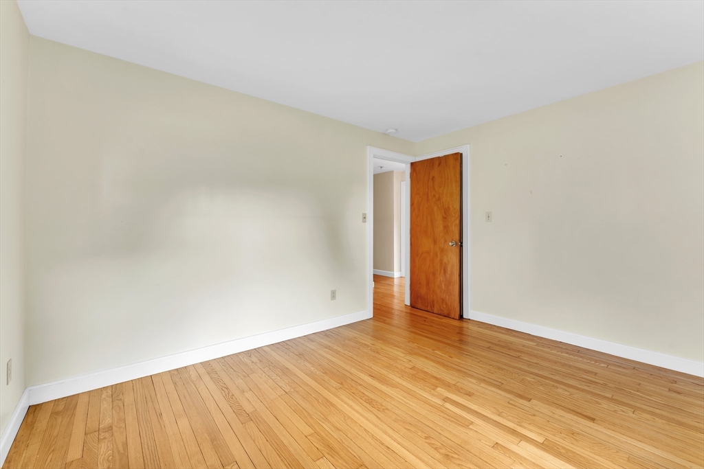 1127 East Street North Suffield, CT 06078 - Photo 24 of 40 a view of an empty room with wooden floor