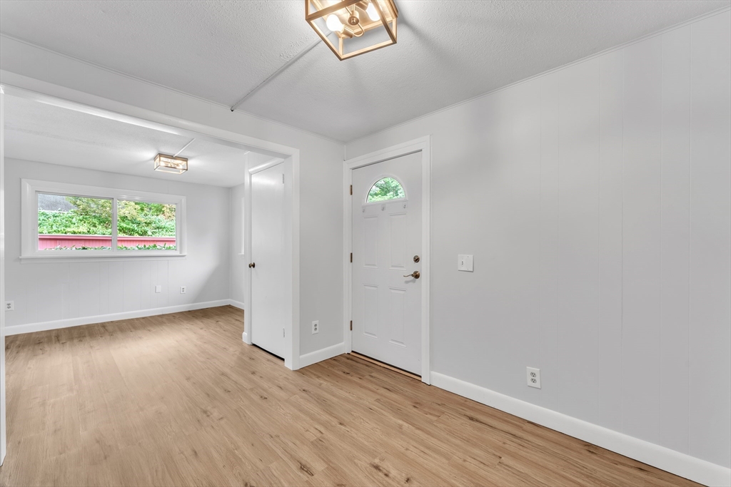 1127 East Street North Suffield, CT 06078 - Photo 26 of 40 an empty room with wooden floor and windows