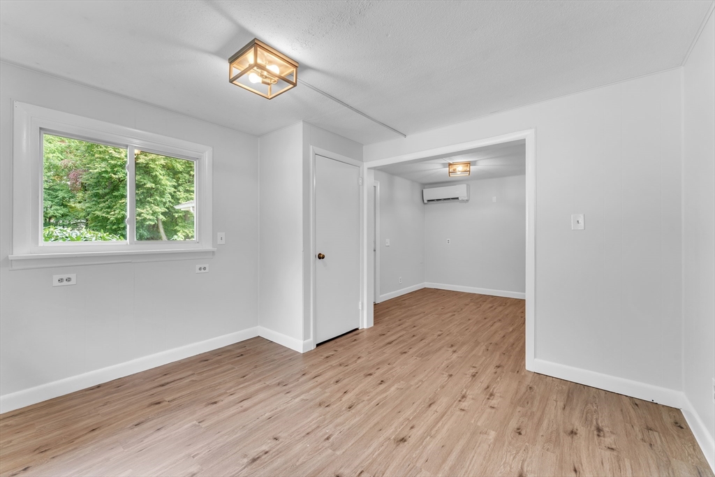 1127 East Street North Suffield, CT 06078 - Photo 27 of 40 a view of empty room with wooden floor and fan
