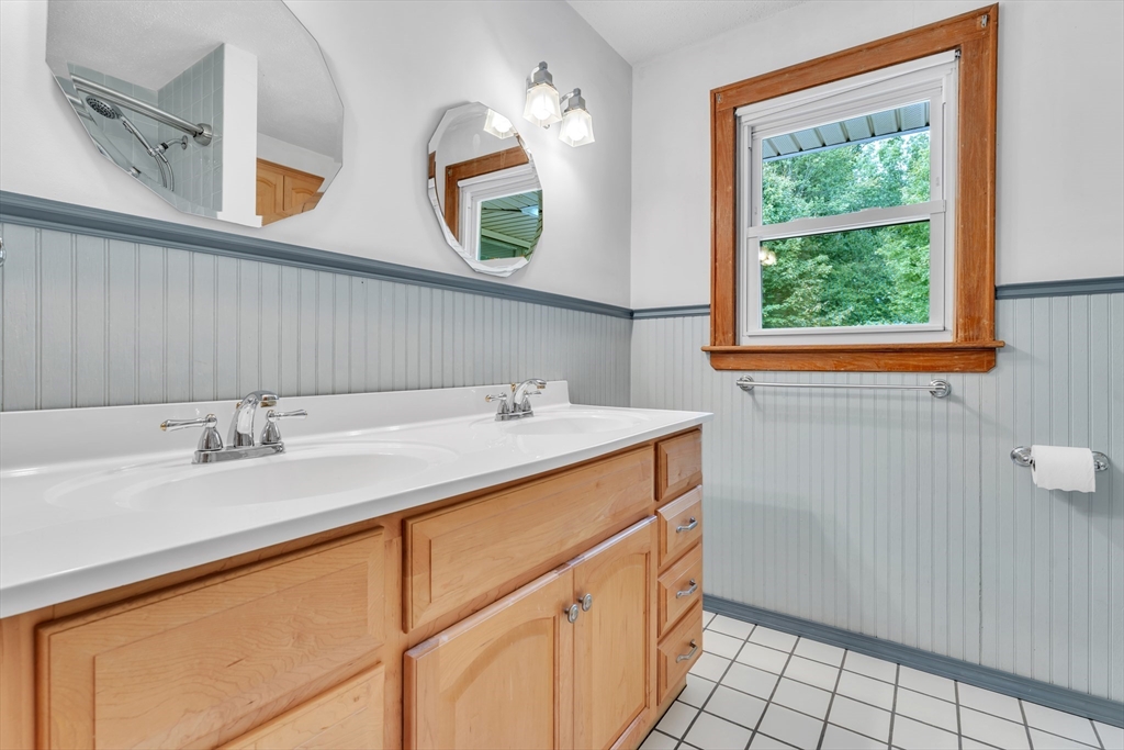1127 East Street North Suffield, CT 06078 - Photo 30 of 40 a bathroom with a sink and a mirror