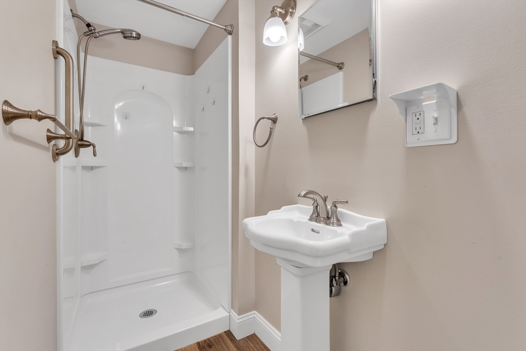 1127 East Street North Suffield, CT 06078 - Photo 32 of 40 a bathroom with a shower a mirror and a sink