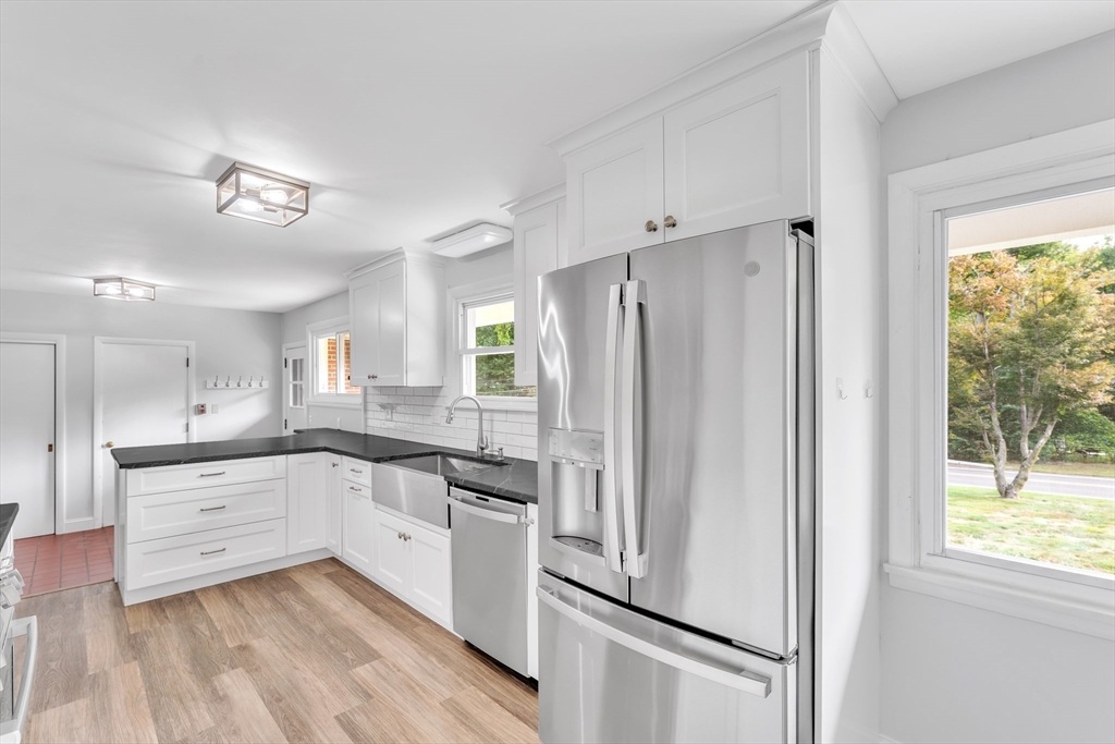 1127 East Street North Suffield, CT 06078 - Photo 6 of 40 a kitchen with white cabinets and white appliances