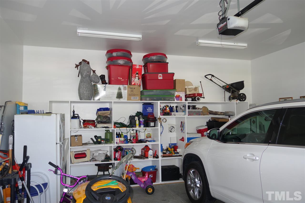 63 West Waycliff Road Henderson, NC 27537 - Photo 22 of 24 The double garage is finished inside with some shelves attached to the back wall and also has an electric door opener.