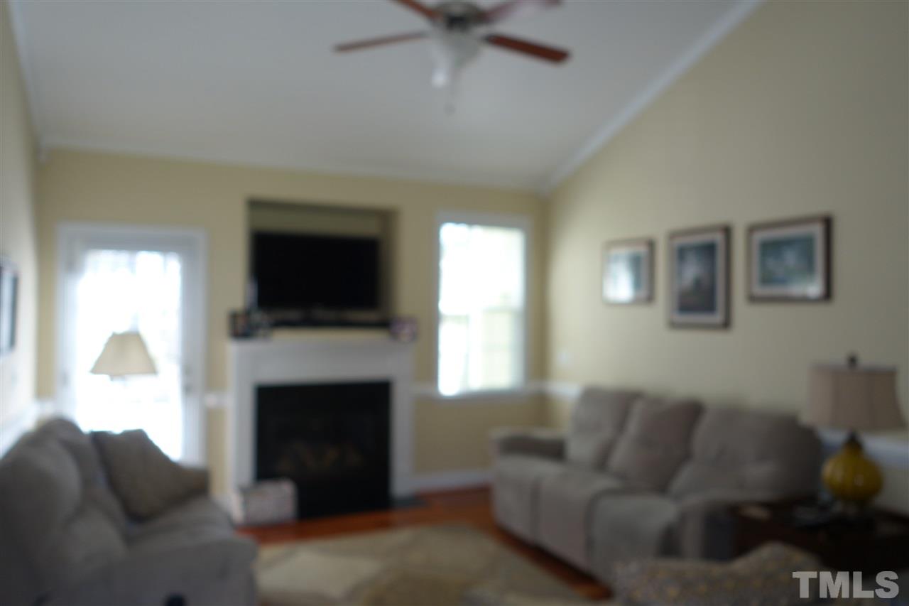 63 West Waycliff Road Henderson, NC 27537 - Photo 6 of 24 Family room with beautiful wood floor and natural gas log fireplace.