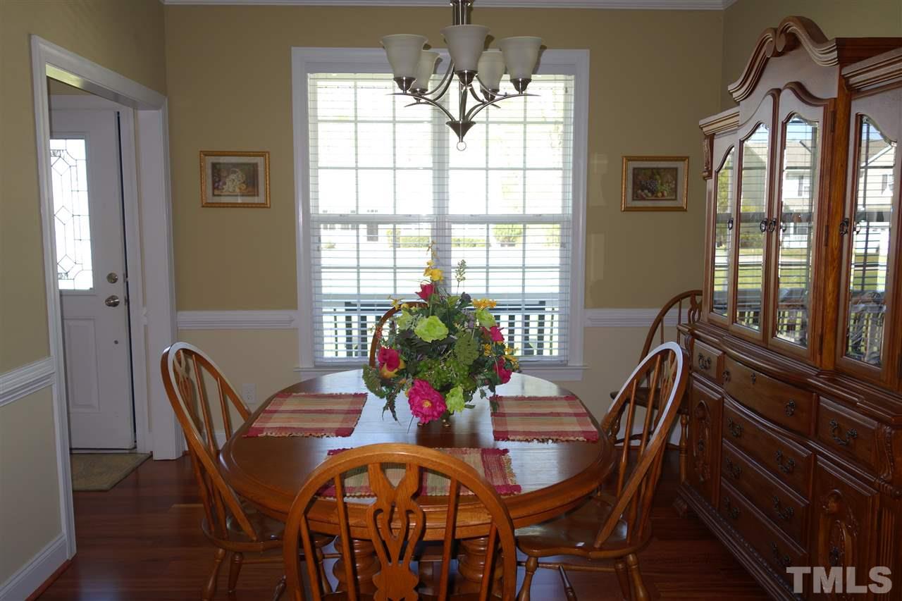 63 West Waycliff Road Henderson, NC 27537 - Photo 7 of 24 Formal dining room with chair rail, crown molding and wood flooring