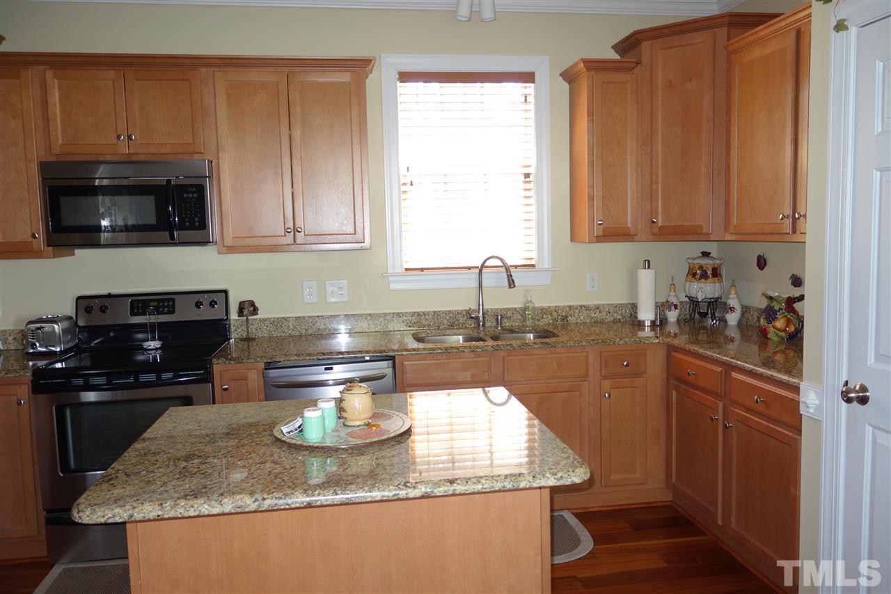 63 West Waycliff Road Henderson, NC 27537 - Photo 9 of 24 The kitchen is equipped with electric range, microwave, dishwasher, refrigerator and disposal