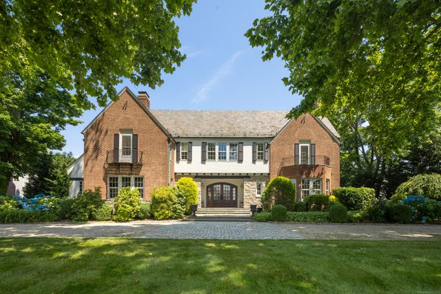a front view of a house with a garden