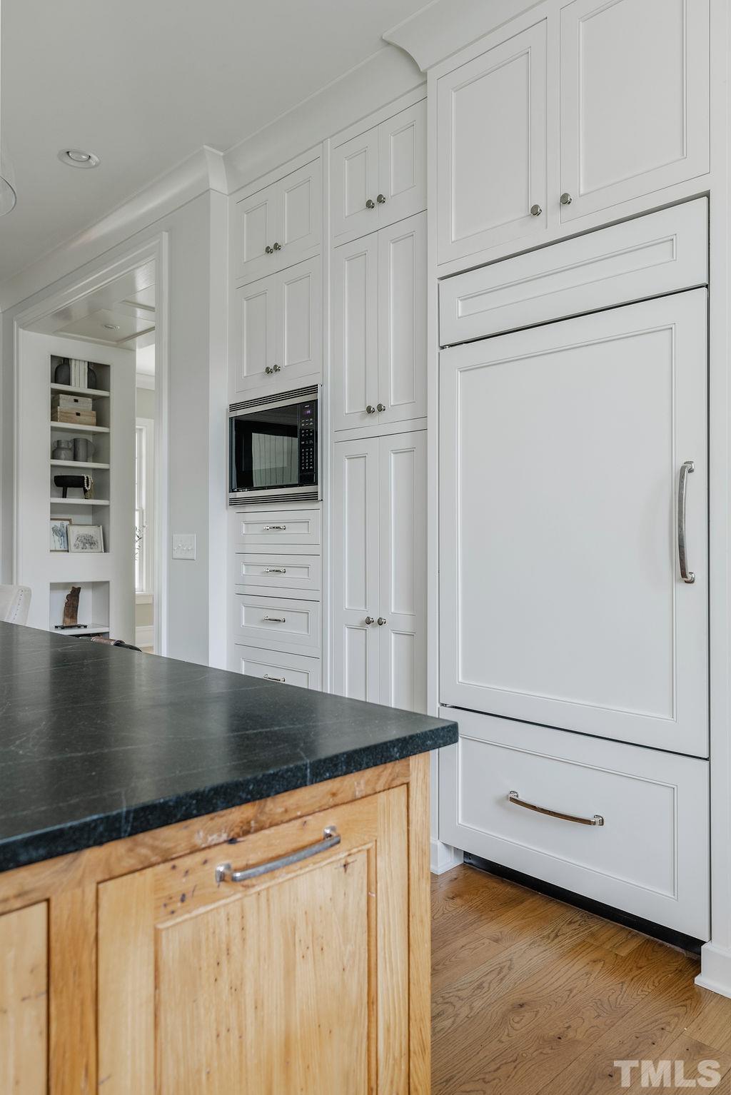 4427 Laurel Hills Road Raleigh, NC 27612 - Photo 27 of 89 a kitchen with granite countertop white cabinets and white appliances