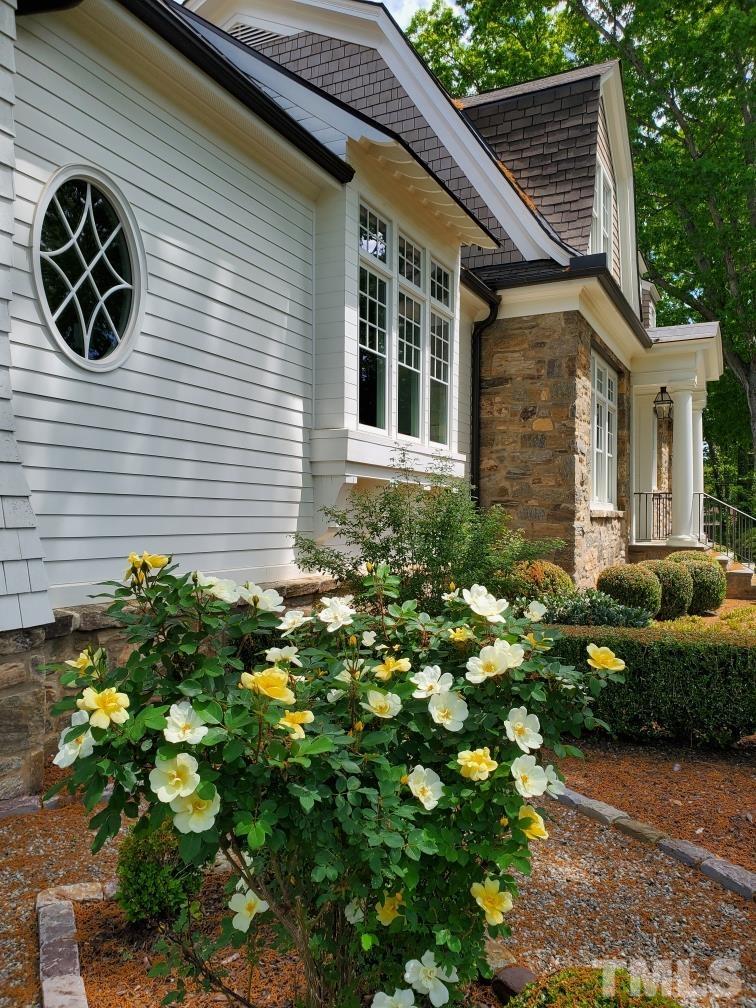 4427 Laurel Hills Road Raleigh, NC 27612 - Photo 3 of 89 a front view of a house with a yard