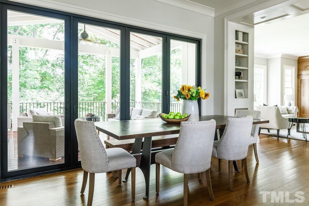 4427 Laurel Hills Road Raleigh, NC 27612 - Photo 31 of 89 a view of a dining room with furniture and wooden floor