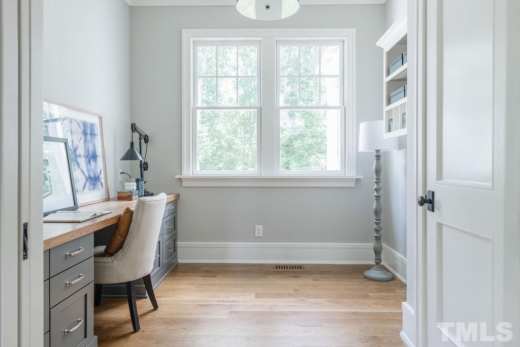 4427 Laurel Hills Road Raleigh, NC 27612 - Photo 32 of 89 a view of a workspace with furniture and a window