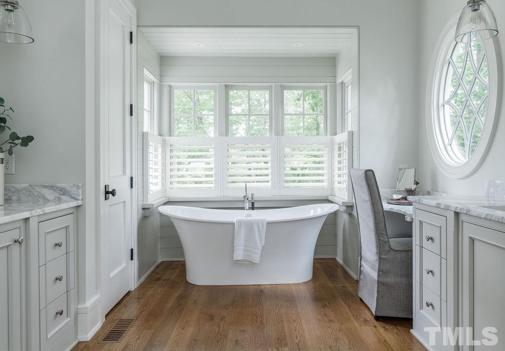 4427 Laurel Hills Road Raleigh, NC 27612 - Photo 50 of 89 a living room with a large window and wooden floor