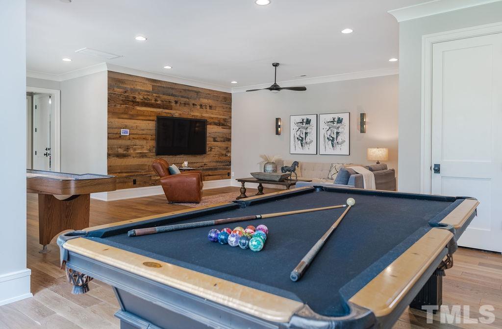 4427 Laurel Hills Road Raleigh, NC 27612 - Photo 58 of 89 a living room with furniture pool table and a flat screen tv