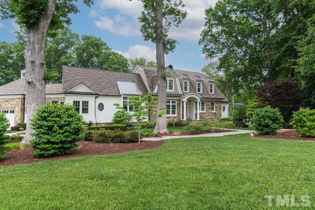 4427 Laurel Hills Road Raleigh, NC 27612 - Photo 73 of 89 a front view of a house with a yard table and chairs