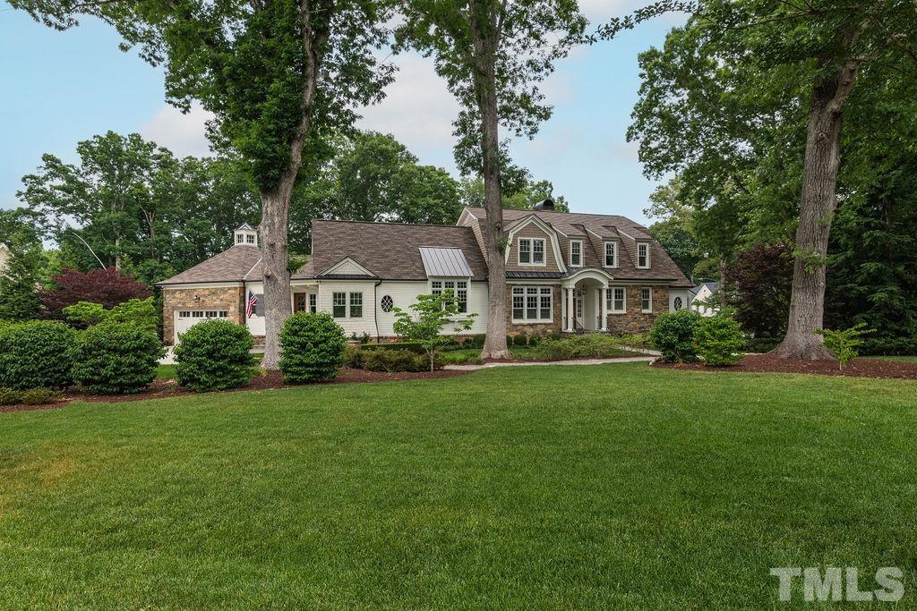 4427 Laurel Hills Road Raleigh, NC 27612 - Photo 78 of 89 a front view of a house with a garden