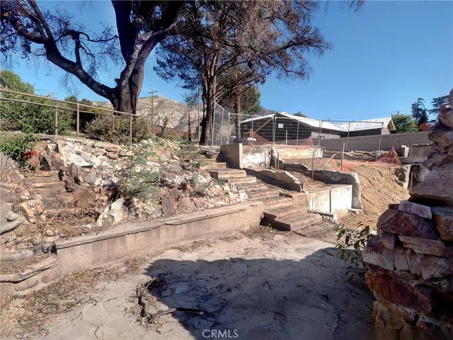 a view of a backyard with large trees