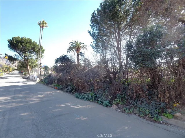 a view of a yard with cars on road