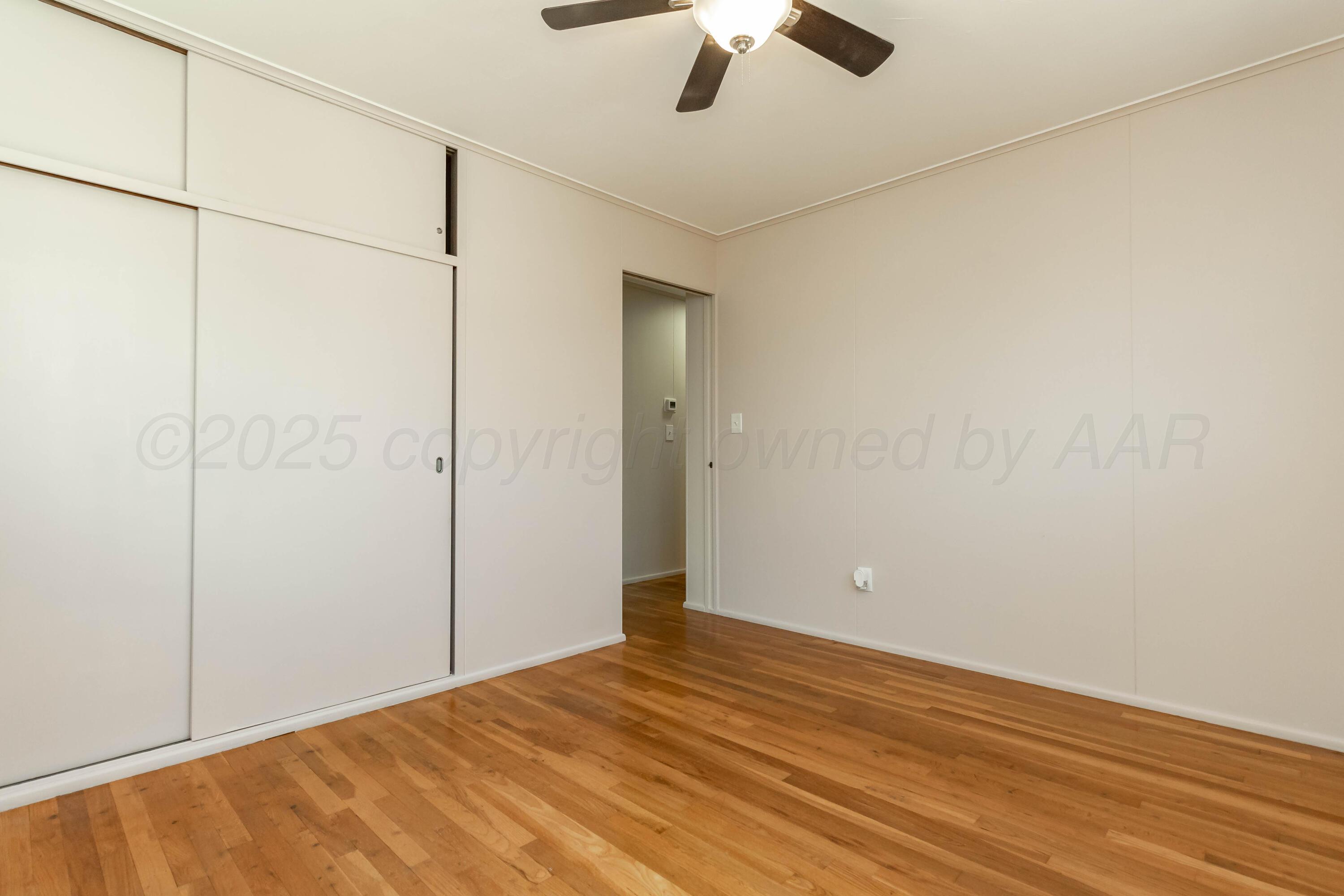 5207 Tumbleweed Drive Amarillo, TX 79110 - Photo 12 of 19 a view of empty room with wooden floor