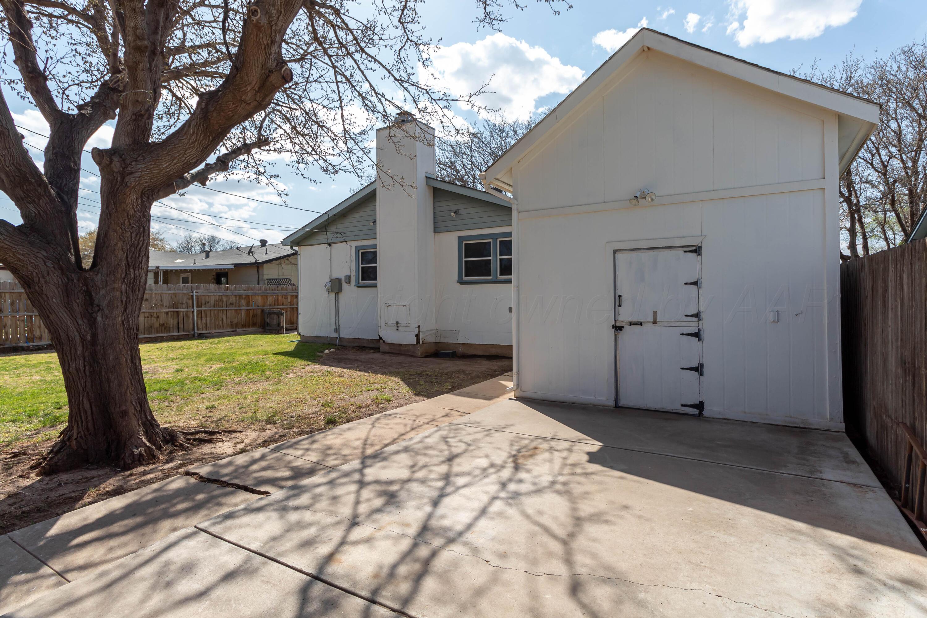 5207 Tumbleweed Drive Amarillo, TX 79110 - Photo 16 of 19 a view of a house with a tree in the yard