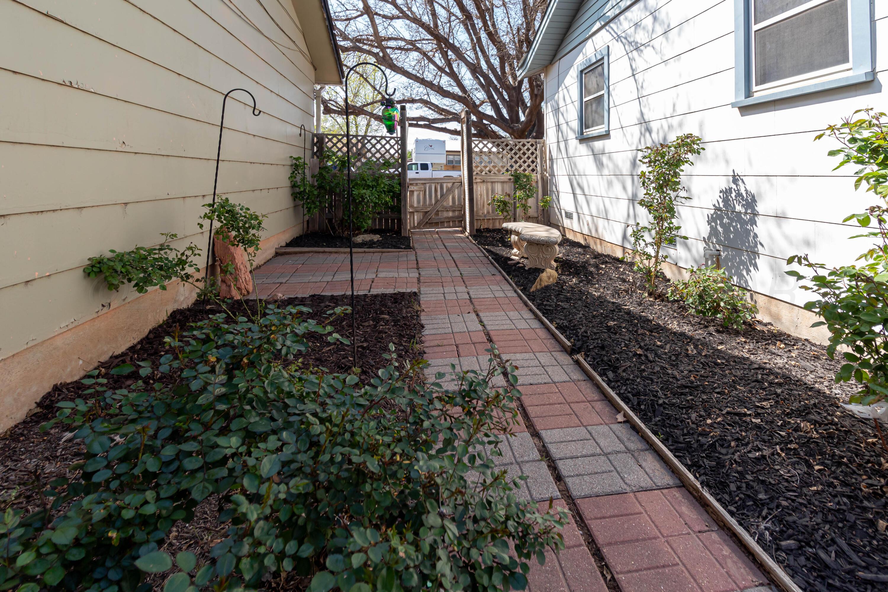 5207 Tumbleweed Drive Amarillo, TX 79110 - Photo 18 of 19 a view of a pathway with flower plants
