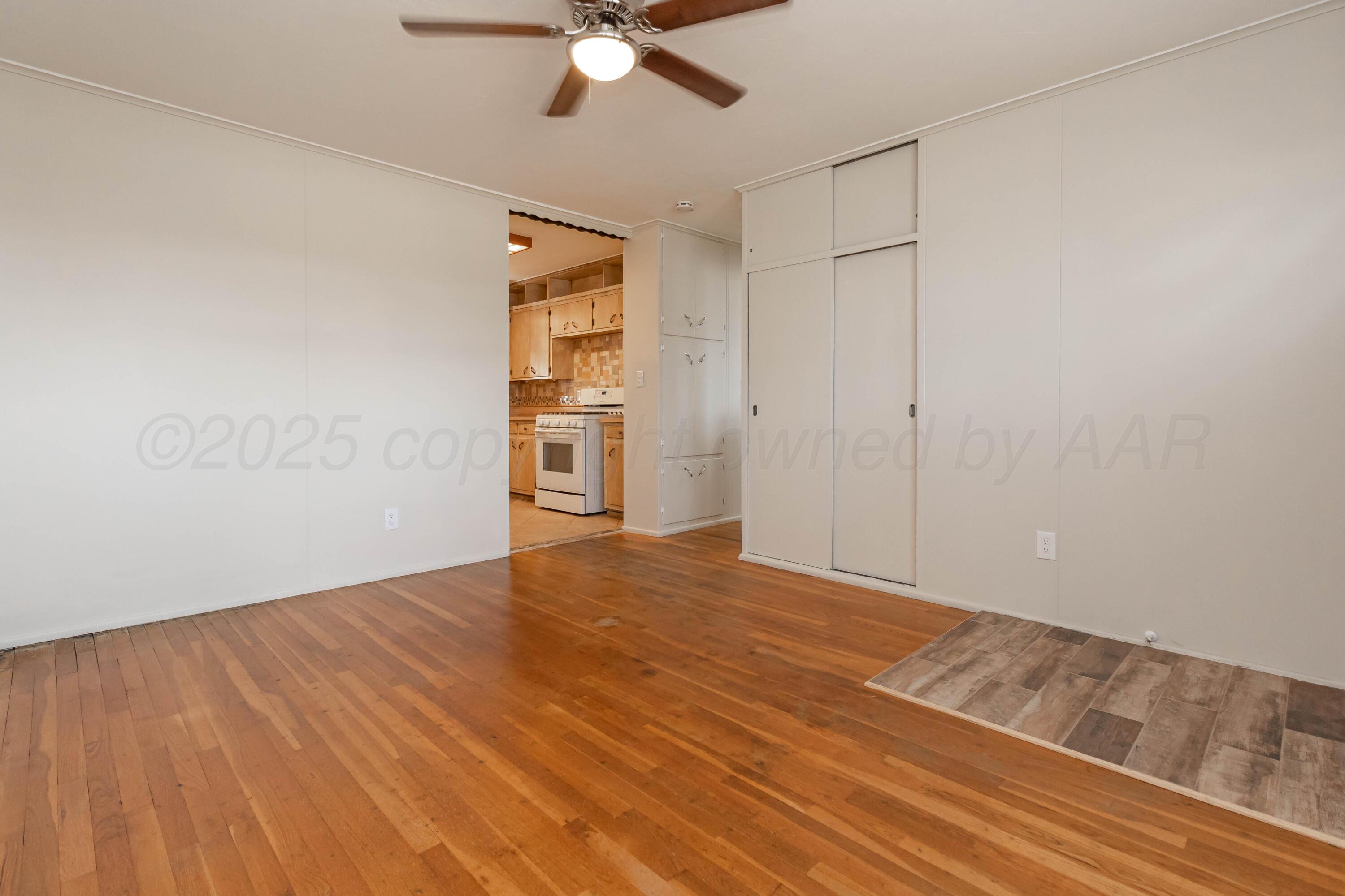 5207 Tumbleweed Drive Amarillo, TX 79110 - Photo 3 of 19 a view of an empty room with wooden floor
