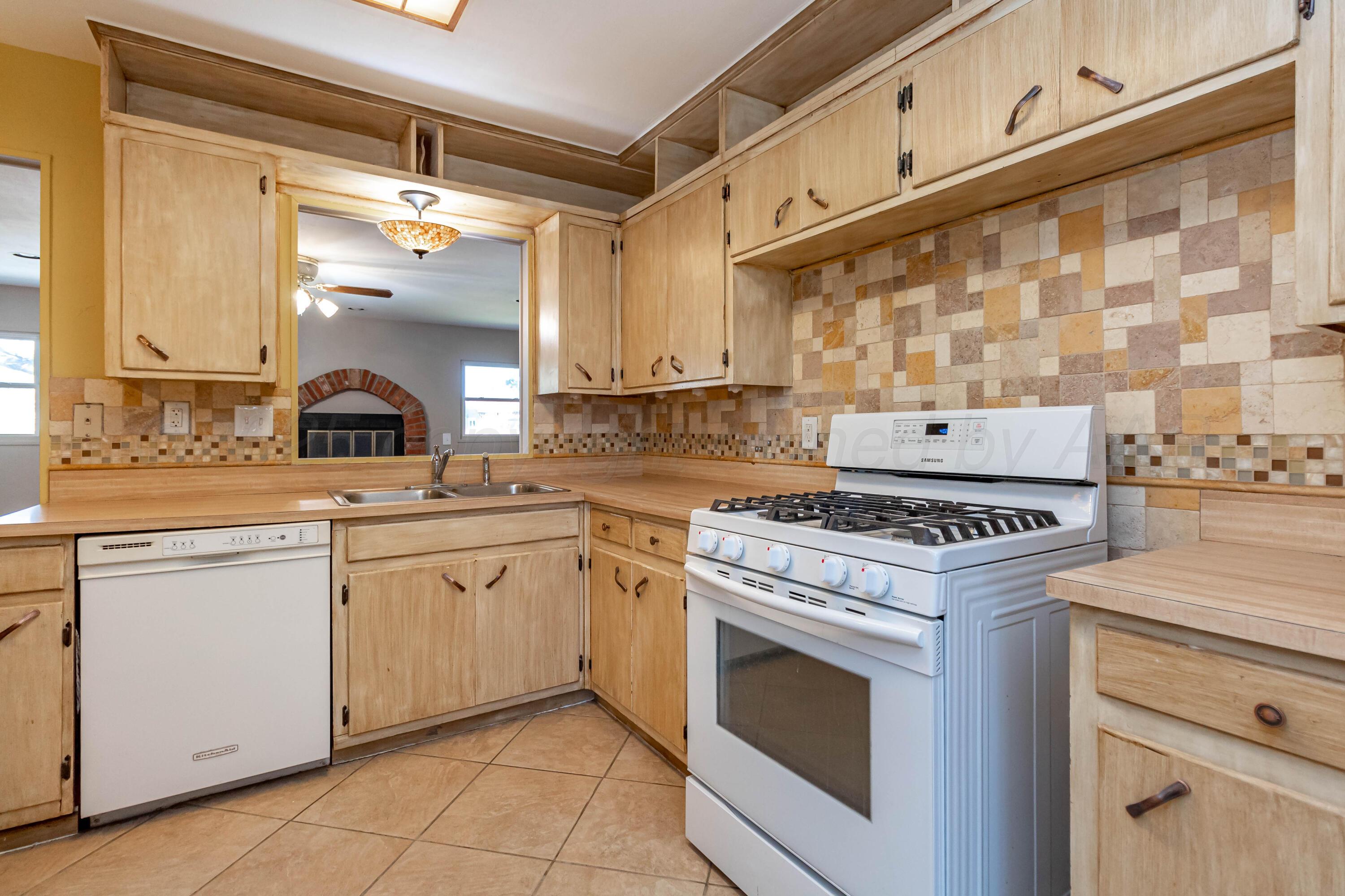 5207 Tumbleweed Drive Amarillo, TX 79110 - Photo 5 of 19 a kitchen with stainless steel appliances granite countertop a stove and a sink