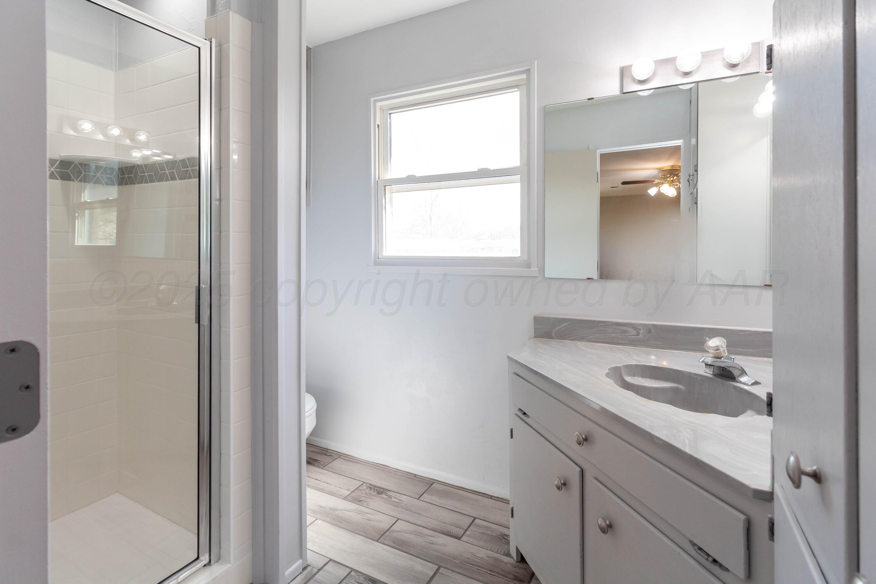 5207 Tumbleweed Drive Amarillo, TX 79110 - Photo 9 of 19 a bathroom with a sink and a mirror