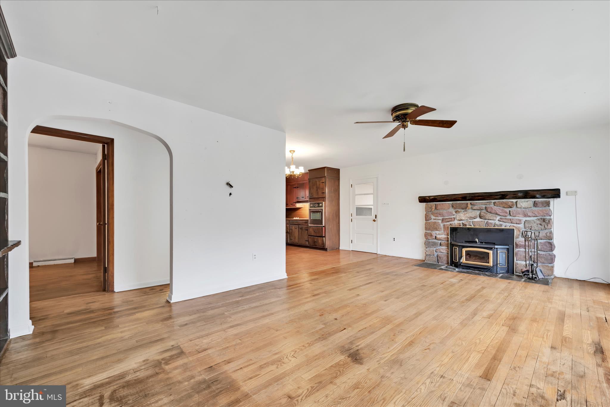 444 North Heidelberg Road Robesonia, PA 19551 - Photo 12 of 59 a view of empty room with a fireplace and wooden floor