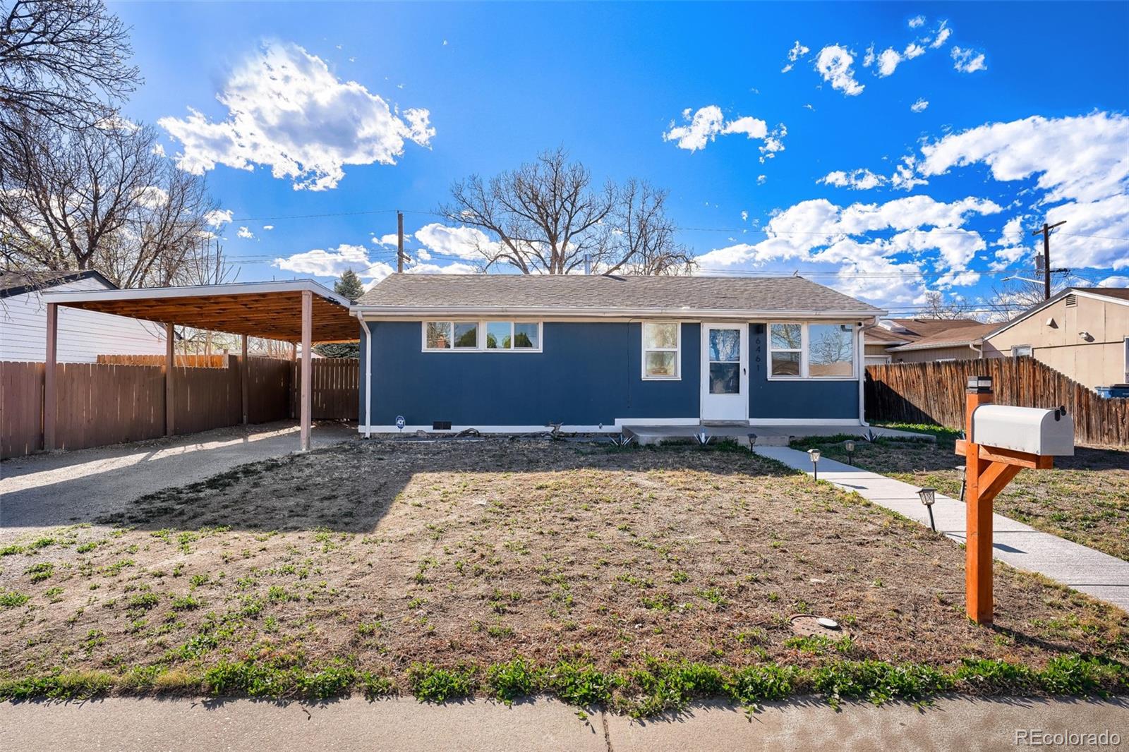 6461 Porter Way Commerce City, CO 80022 - Photo 1 of 23 a view of a house with a yard
