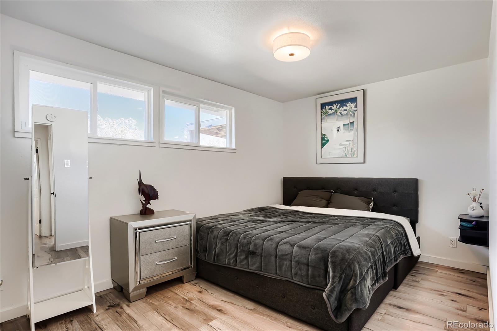 6461 Porter Way Commerce City, CO 80022 - Photo 13 of 23 a bedroom with a bed and a closet