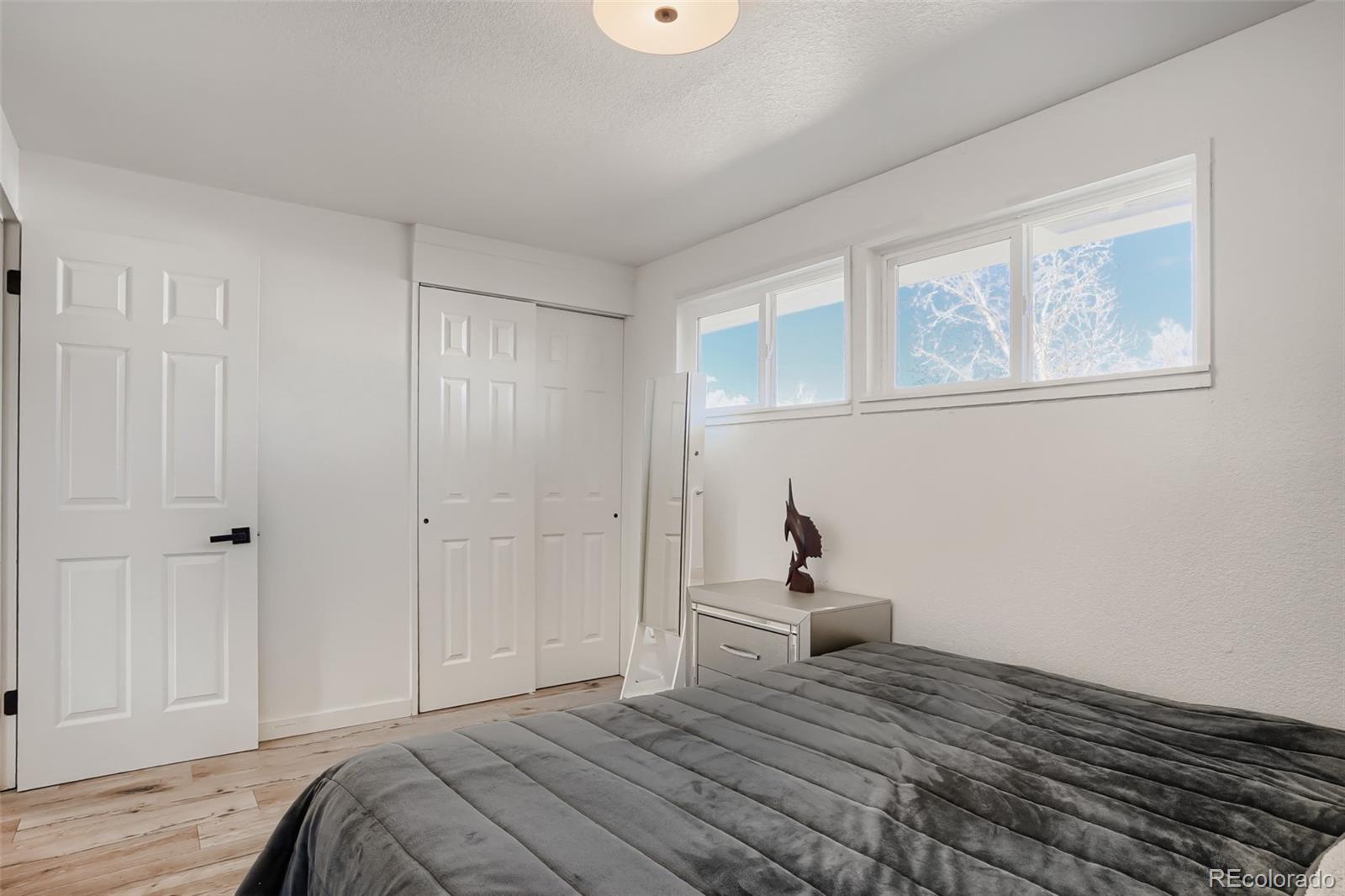 6461 Porter Way Commerce City, CO 80022 - Photo 14 of 23 a bedroom with a bed and a window