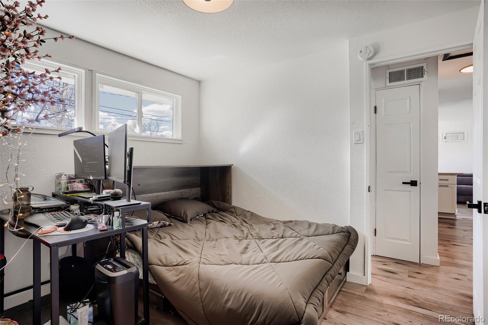 6461 Porter Way Commerce City, CO 80022 - Photo 18 of 23 a bedroom with a bed and a table