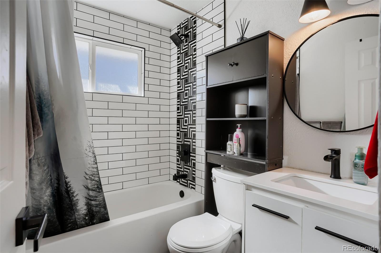 6461 Porter Way Commerce City, CO 80022 - Photo 19 of 23 a bathroom with a toilet a sink and bathtub