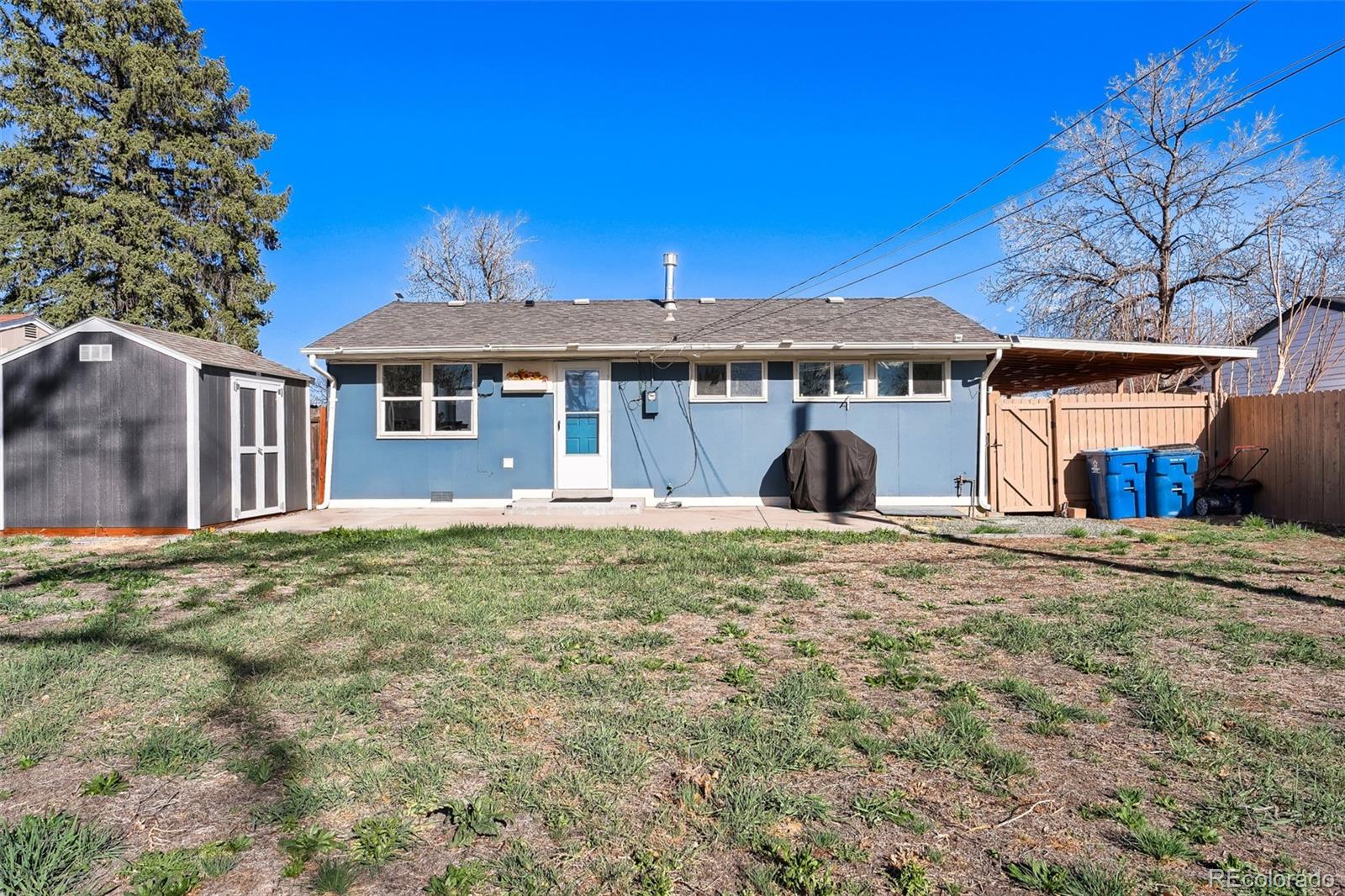 6461 Porter Way Commerce City, CO 80022 - Photo 20 of 23 a front view of a house with a yard