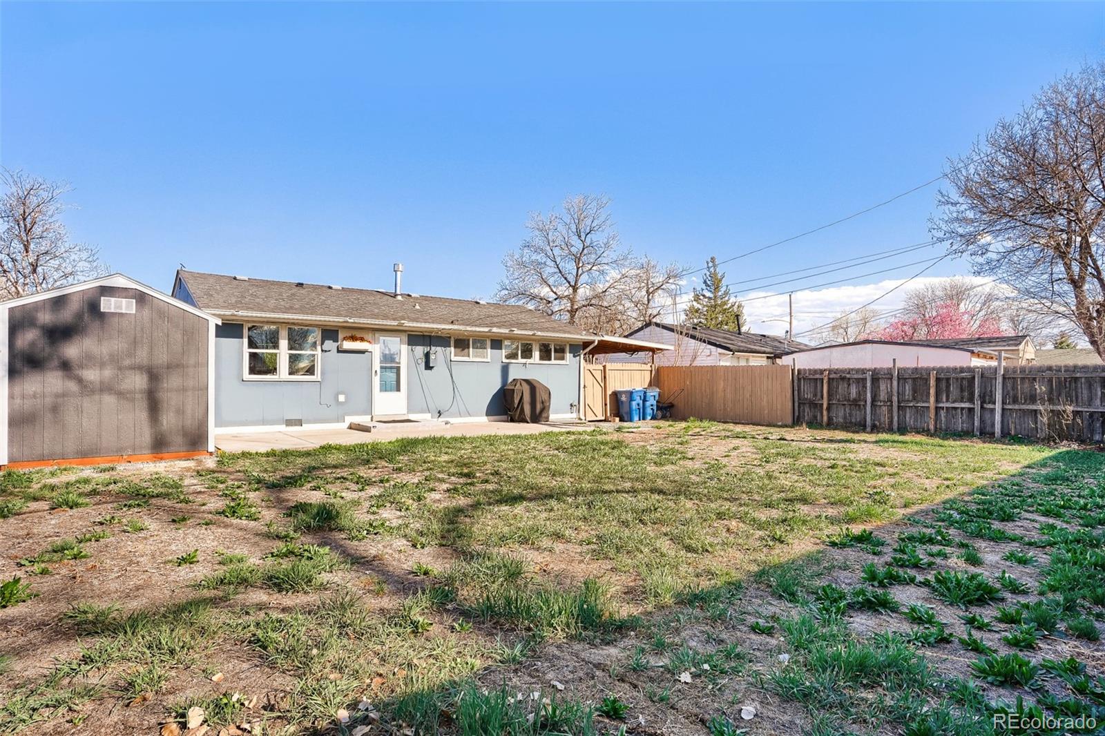 6461 Porter Way Commerce City, CO 80022 - Photo 21 of 23 a large house with a big yard and large trees