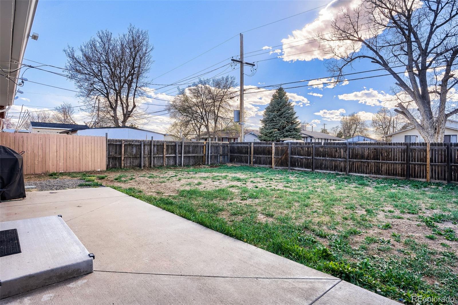 6461 Porter Way Commerce City, CO 80022 - Photo 22 of 23 a view of a backyard with a garden