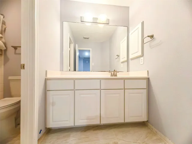 a white toilet sitting next to a bath tub and a shower