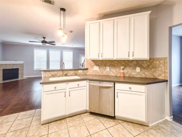 a kitchen with a sink cabinets and window