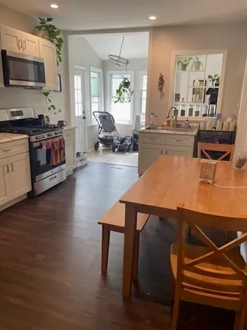 a living room with furniture wooden floor and a flat screen tv