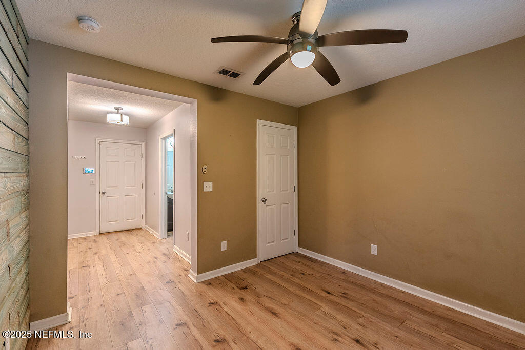 348 Auburn Oaks Road East Jacksonville, FL 32218 - Photo 13 of 30 an empty room with wooden floor and windows